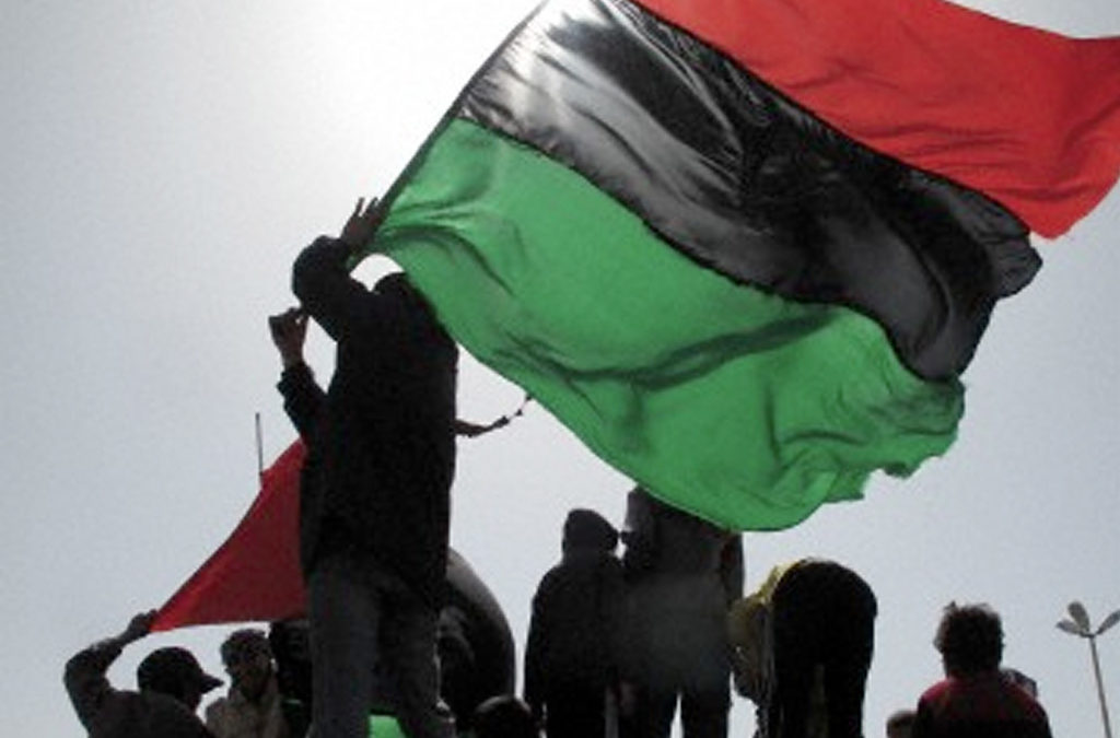 In Benghazi, capital of the Libyan revolution, people demonstrate against Qaddafi with the flag of the new "free Libya."